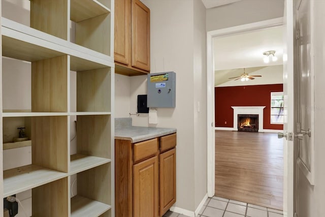 15108 Springview St, Tampa, FL 33624 - kitchen with open shelves, ceiling fan, and a lit fireplace
