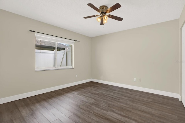 15108 Springview St, Tampa, FL 33624 - spare room featuring dark wood-style floors, baseboards, and a ceiling fan