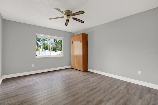 15108 Springview St, Tampa, FL 33624 - spare room with wood finished floors, ceiling fan, and baseboards