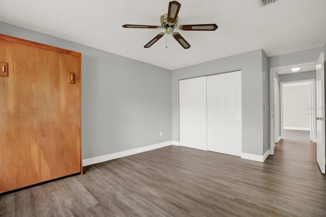 15108 Springview St, Tampa, FL 33624 - unfurnished bedroom with wood finished floors, baseboards, a closet, and a ceiling fan