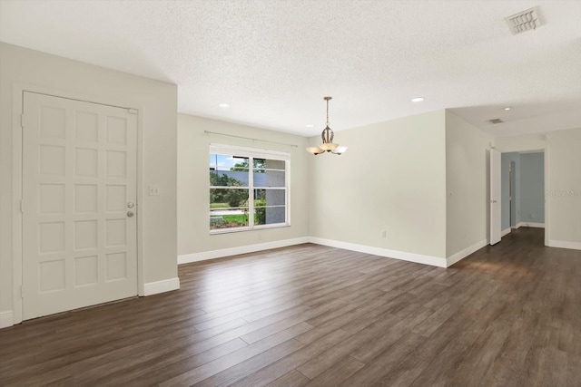 15108 Springview St, Tampa, FL 33624 - foyer entrance featuring a chandelier, a textured ceiling, dark wood-style floors, baseboards, and recessed lighting