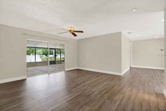 15108 Springview St, Tampa, FL 33624 - empty room featuring a ceiling fan, dark wood-style floors, baseboards, and a textured ceiling