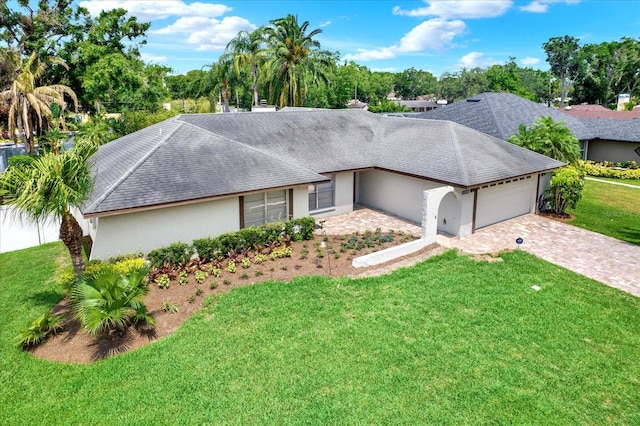 15108 Springview St, Tampa, FL 33624 - ranch-style home with a garage, stucco siding, a front yard, and driveway