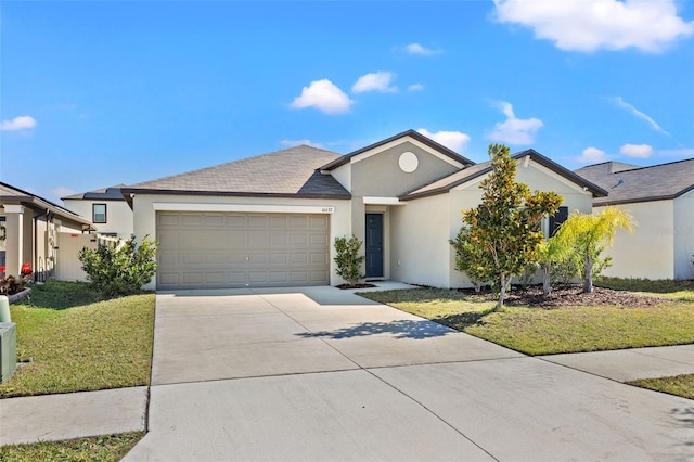 16632 Sunburst Lake St, Wimauma, FL 33598 - view of front of house with stucco siding, an attached garage, driveway, and a front lawn