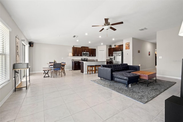 16632 Sunburst Lake St, Wimauma, FL 33598 - living room with ceiling fan, light tile patterned floors, baseboards, and recessed lighting