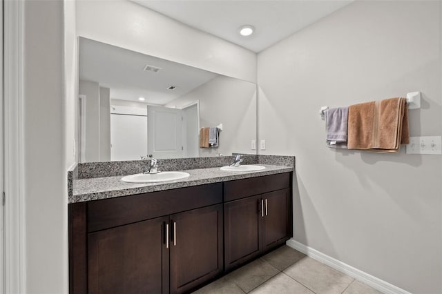 16632 Sunburst Lake St, Wimauma, FL 33598 - full bath featuring double vanity, tile patterned floors, and baseboards