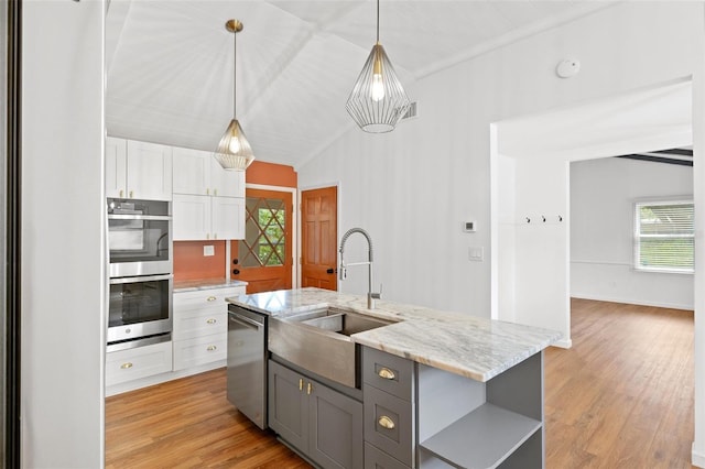 509 Falmouth St, Temple Terrace, FL 33617 - kitchen with appliances with stainless steel finishes, a sink, open shelves, white cabinetry, and a center island with sink