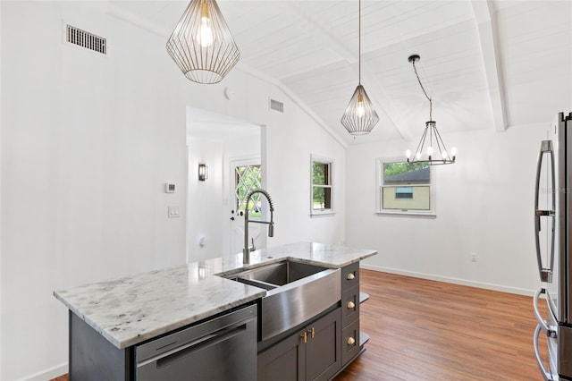 509 Falmouth St, Temple Terrace, FL 33617 - kitchen with stainless steel appliances, a sink, a chandelier, and baseboards