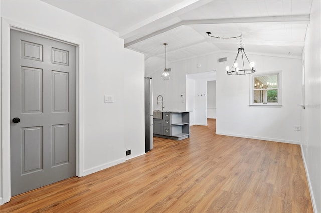 509 Falmouth St, Temple Terrace, FL 33617 - unfurnished living room featuring a chandelier, light wood finished floors, and baseboards