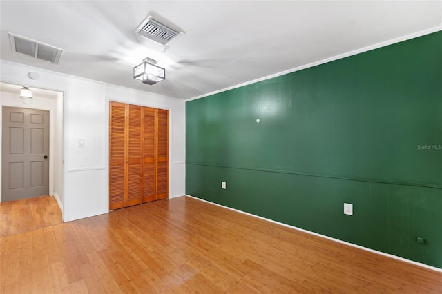 509 Falmouth St, Temple Terrace, FL 33617 - unfurnished bedroom featuring wood finished floors, a closet, and ornamental molding