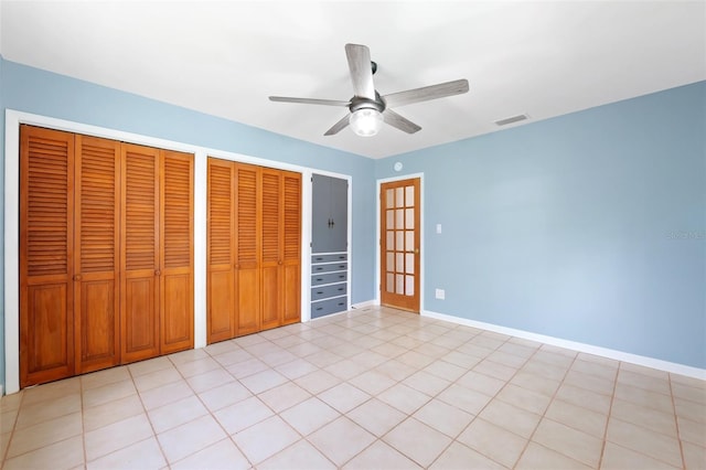 509 Falmouth St, Temple Terrace, FL 33617 - unfurnished bedroom with two closets, ceiling fan, and baseboards