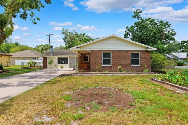 509 Falmouth St, Temple Terrace, FL 33617 - ranch-style home with brick siding and driveway