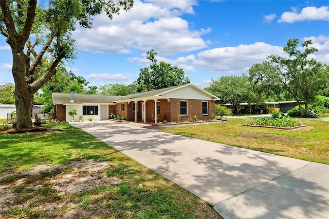 509 Falmouth St, Temple Terrace, FL 33617 - ranch-style home with concrete driveway, a front lawn, and brick siding