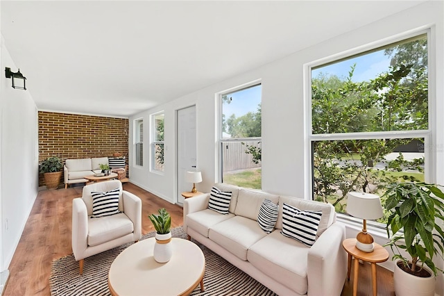 509 Falmouth St, Temple Terrace, FL 33617 - living area with brick wall and light wood-style flooring
