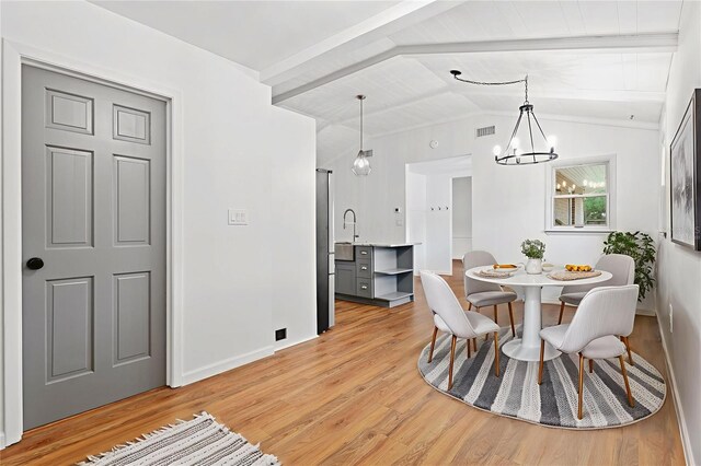 509 Falmouth St, Temple Terrace, FL 33617 - dining room featuring light wood finished floors, a chandelier, and baseboards