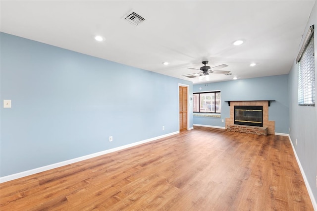 509 Falmouth St, Temple Terrace, FL 33617 - unfurnished living room with healthy amount of natural light, a ceiling fan, recessed lighting, a brick fireplace, and baseboards