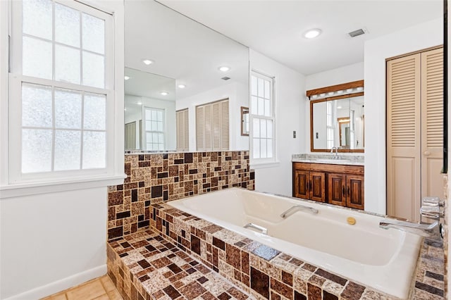 509 Falmouth St, Temple Terrace, FL 33617 - full bath featuring a garden tub, a closet, vanity, tile patterned flooring, and recessed lighting