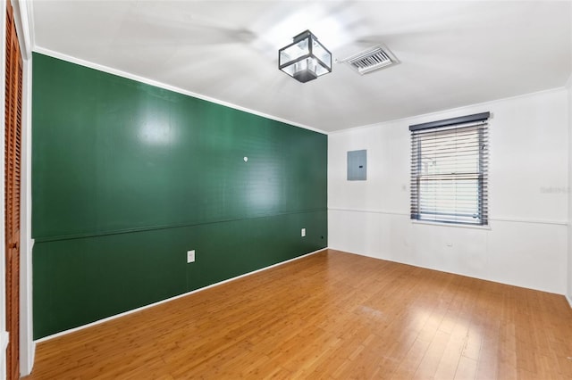 509 Falmouth St, Temple Terrace, FL 33617 - empty room featuring ornamental molding, wood finished floors, and electric panel