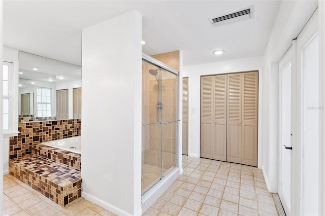 509 Falmouth St, Temple Terrace, FL 33617 - bathroom with a closet, tile patterned floors, a stall shower, a garden tub, and recessed lighting