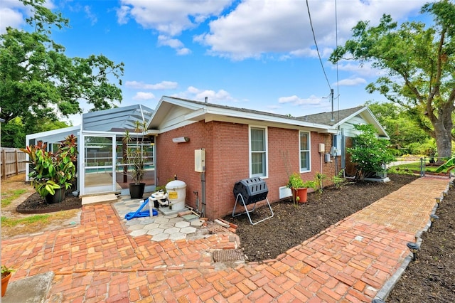 509 Falmouth St, Temple Terrace, FL 33617 - back of property featuring brick siding and a patio area