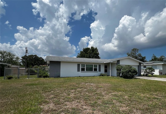 2195 Academy Dr, Clearwater, FL 33764 - ranch-style house with an attached garage, stucco siding, and driveway