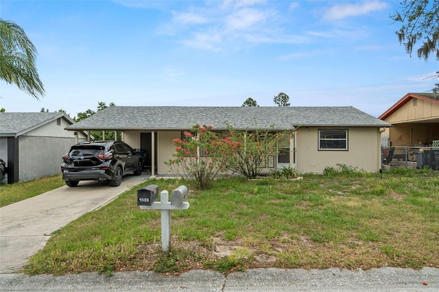 4150 Pecos Dr, New Port Richey, FL 34653 - ranch-style house featuring driveway and an attached carport