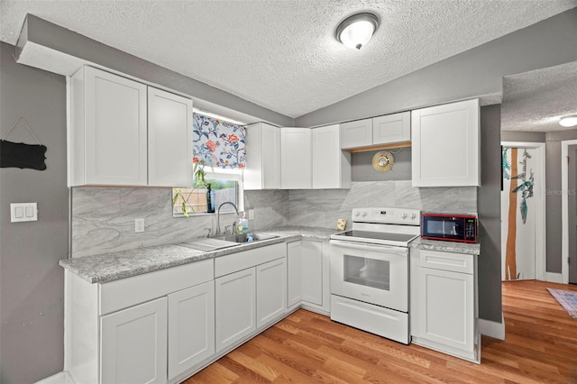 4150 Pecos Dr, New Port Richey, FL 34653 - kitchen featuring electric stove, a sink, a textured ceiling, black microwave, and light countertops