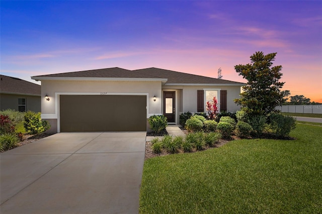 12697 Achasta Blvd, Hudson, FL 34669 - single story home with stucco siding, a garage, a lawn, concrete driveway, and a shingled roof