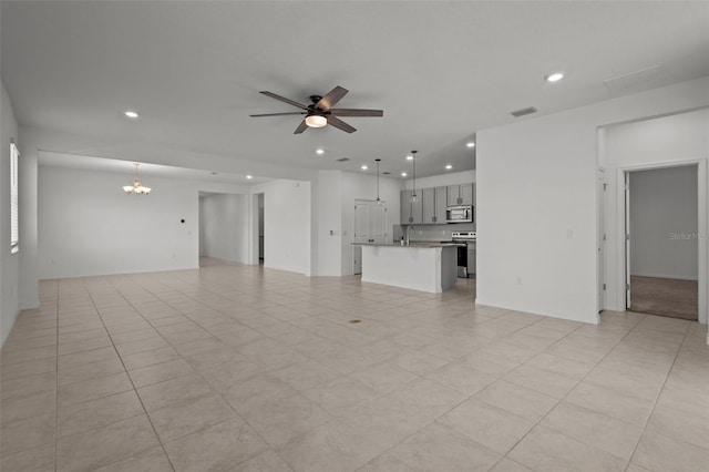 12697 Achasta Blvd, Hudson, FL 34669 - unfurnished living room with recessed lighting, a chandelier, and a ceiling fan