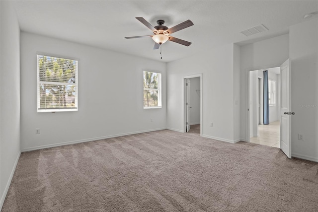 12697 Achasta Blvd, Hudson, FL 34669 - unfurnished bedroom with light colored carpet, multiple windows, baseboards, and a walk in closet