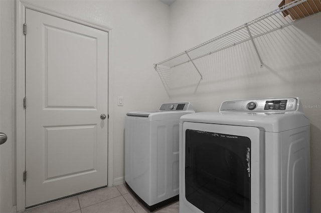 12697 Achasta Blvd, Hudson, FL 34669 - laundry room featuring washer and clothes dryer and light tile patterned floors