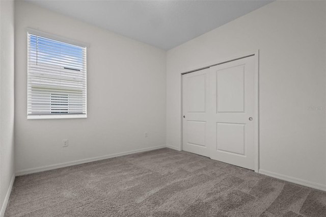 12697 Achasta Blvd, Hudson, FL 34669 - unfurnished bedroom featuring carpet, baseboards, and a closet