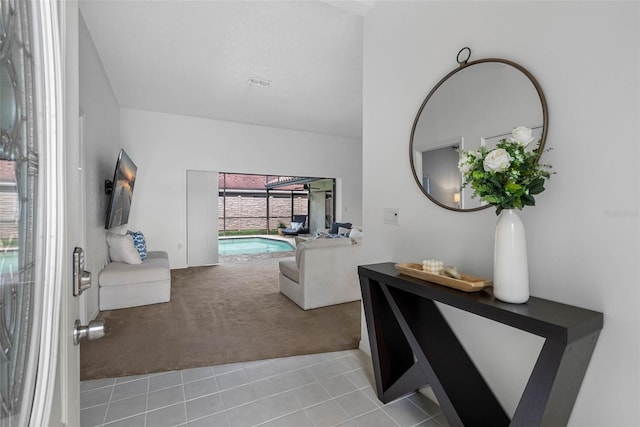 12470 93rd St, Largo, FL 33773 - living room with light carpet, light tile patterned floors, and a sunroom