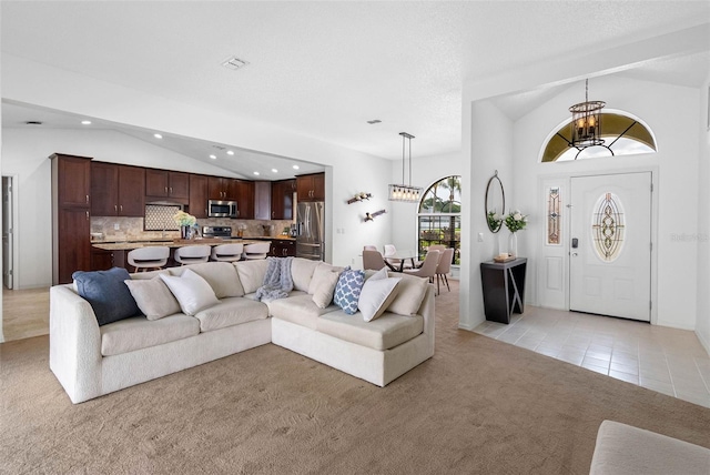 12470 93rd St, Largo, FL 33773 - living area with lofted ceiling, light colored carpet, a chandelier, light tile patterned floors, and recessed lighting