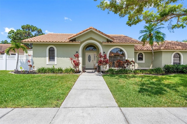 12470 93rd St, Largo, FL 33773 - mediterranean / spanish-style house with stucco siding and a tile roof