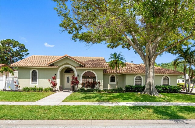 12470 93rd St, Largo, FL 33773 - mediterranean / spanish home featuring stucco siding and a tiled roof