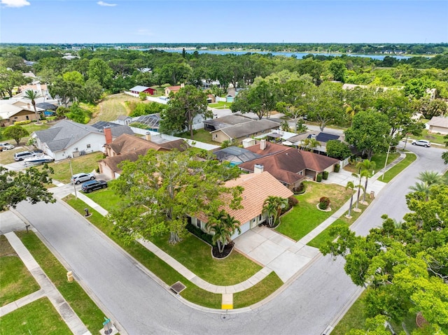 12470 93rd St, Largo, FL 33773 - aerial view of residential area with a large body of water and a tree filled landscape
