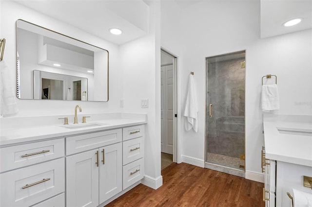 12470 93rd St, Largo, FL 33773 - bathroom with vanity, a stall shower, wood finished floors, and baseboards