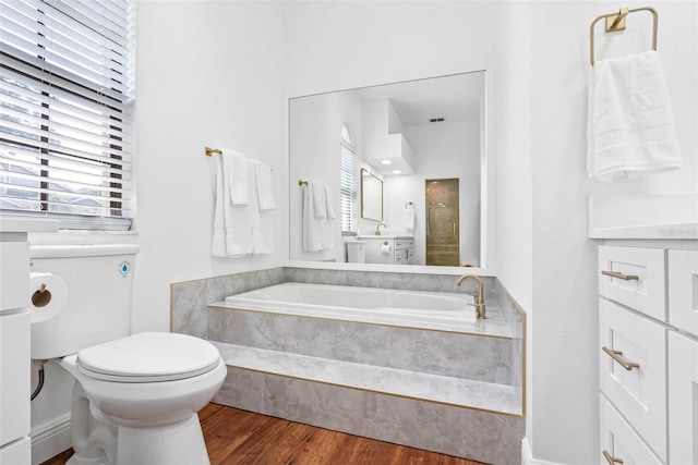 12470 93rd St, Largo, FL 33773 - bathroom featuring a bath, toilet, and wood finished floors
