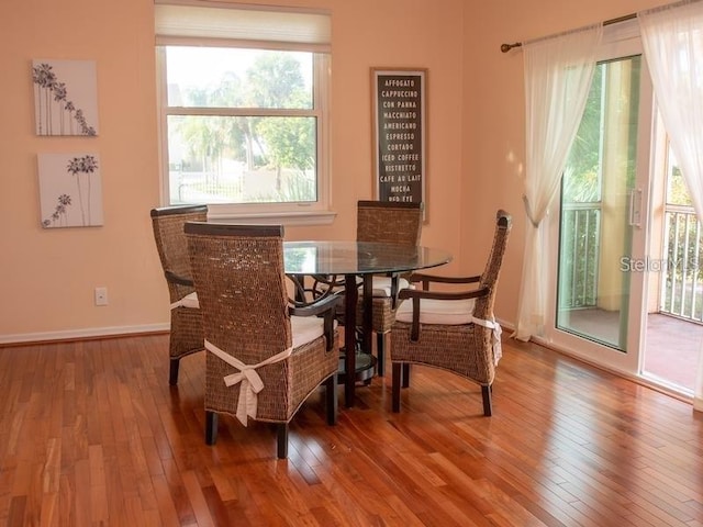 101 8th St, Belleair Beach, FL 33786 - dining space with hardwood / wood-style flooring, healthy amount of natural light, and baseboards