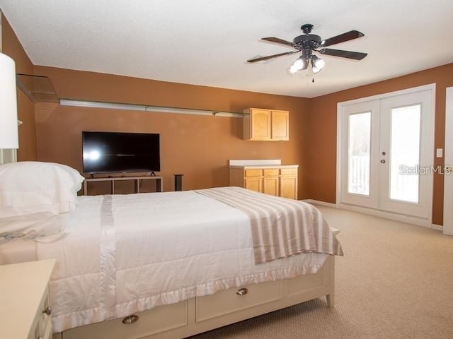 101 8th St, Belleair Beach, FL 33786 - bedroom with light carpet, french doors, baseboards, access to outside, and ceiling fan
