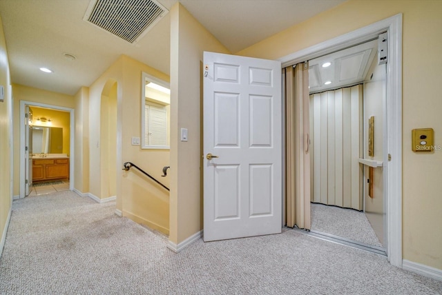 101 8th St, Belleair Beach, FL 33786 - corridor with light carpet, baseboards, an upstairs landing, recessed lighting, and attic access