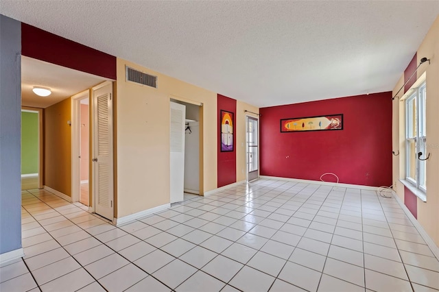 1799 N Highland Ave Unit 3, Clearwater, FL 33755 - spare room with a textured ceiling, light tile patterned flooring, and baseboards