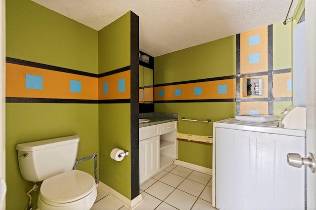 1799 N Highland Ave Unit 3, Clearwater, FL 33755 - bathroom with washer / dryer, vanity, tile patterned flooring, toilet, and a textured ceiling