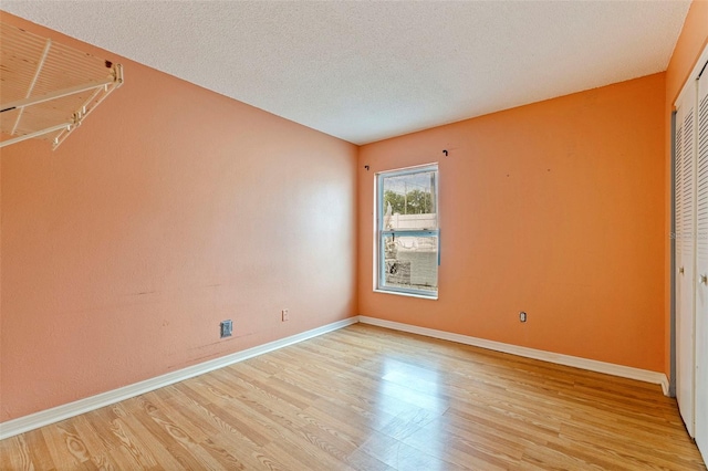 1799 N Highland Ave Unit 3, Clearwater, FL 33755 - spare room with light wood-type flooring, baseboards, and a textured ceiling