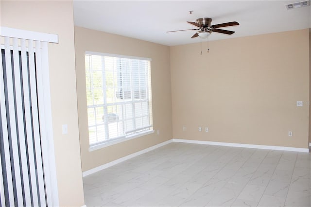 13235 Sanctuary Cove Dr Unit 201, Temple Terrace, FL 33637 - unfurnished room featuring light marble finish flooring, ceiling fan, and plenty of natural light