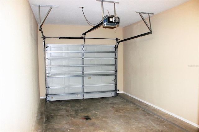 13235 Sanctuary Cove Dr Unit 201, Temple Terrace, FL 33637 - garage featuring a garage door opener and baseboards