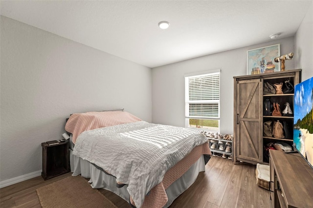 8009 N Primrose Dr, Citrus Springs, FL 34434 - bedroom featuring wood finished floors and baseboards