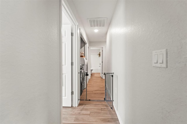 8009 N Primrose Dr, Citrus Springs, FL 34434 - corridor with a textured wall and light wood-style floors