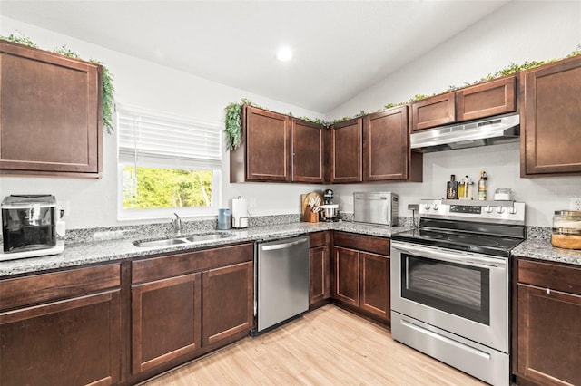 8009 N Primrose Dr, Citrus Springs, FL 34434 - kitchen with under cabinet range hood, stainless steel appliances, a sink, light wood-style floors, and light stone countertops